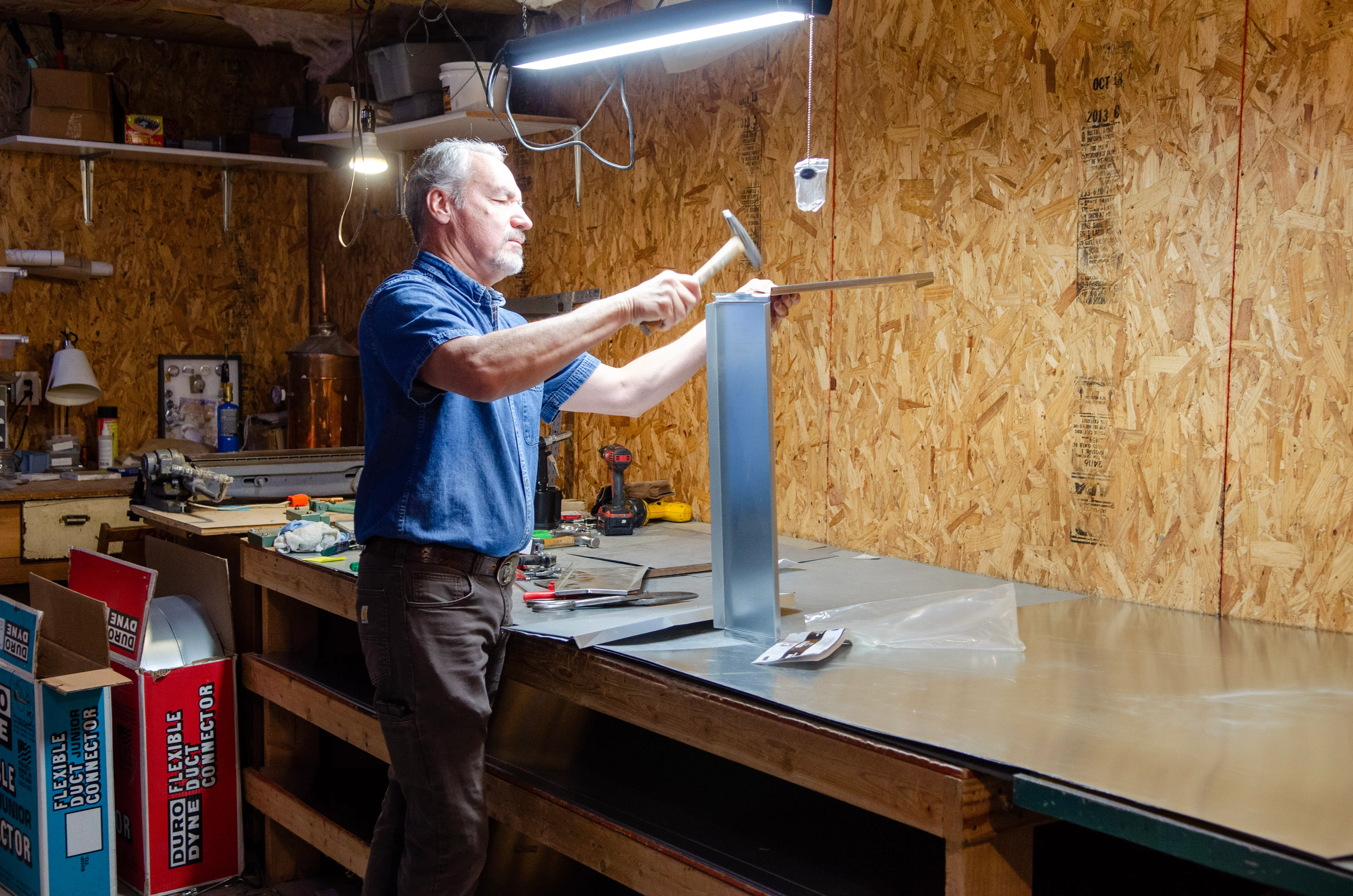 Karl Thomas shaping sheet metal in the KJ Thomas Mechanical shop.