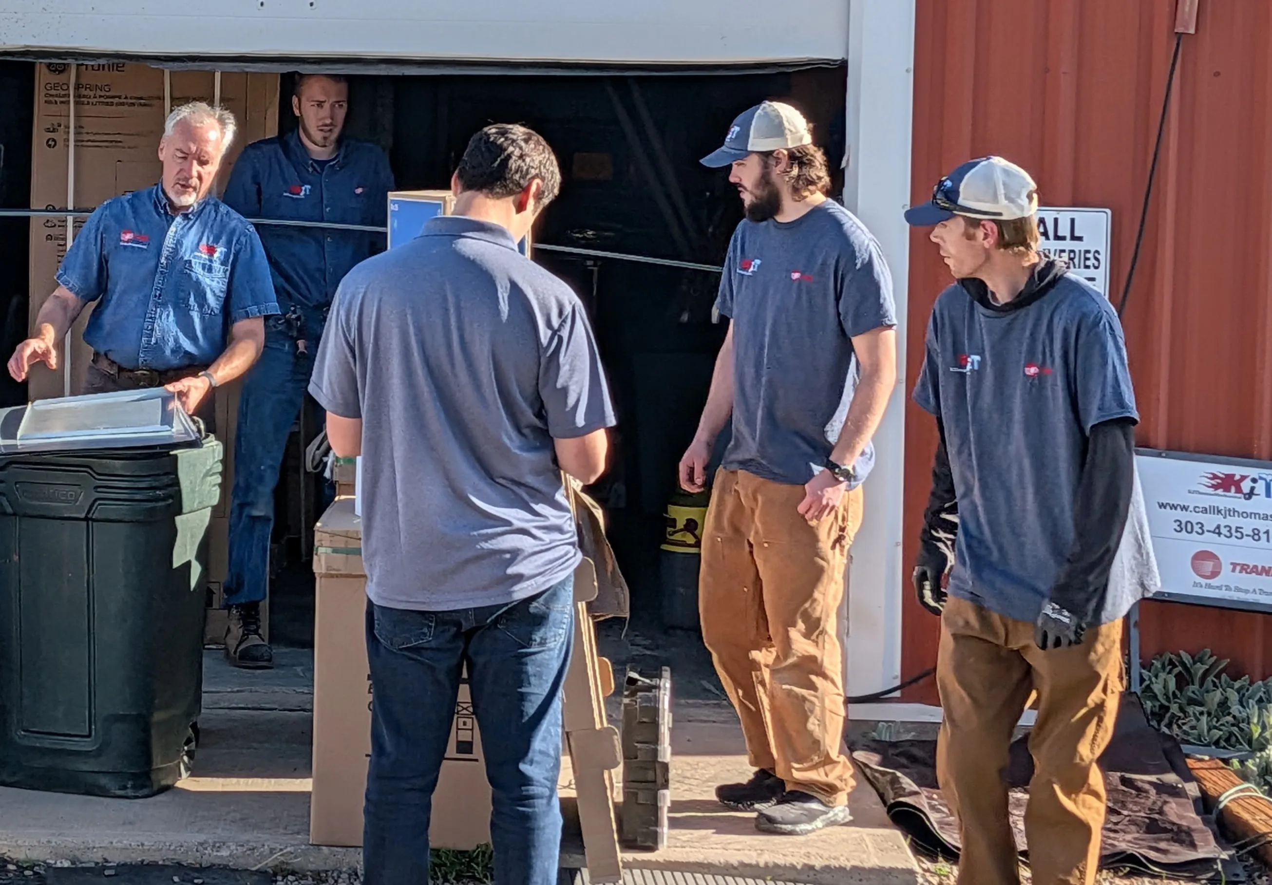 KJ Thomas Mechanical team members coordinating equipment at the shop.