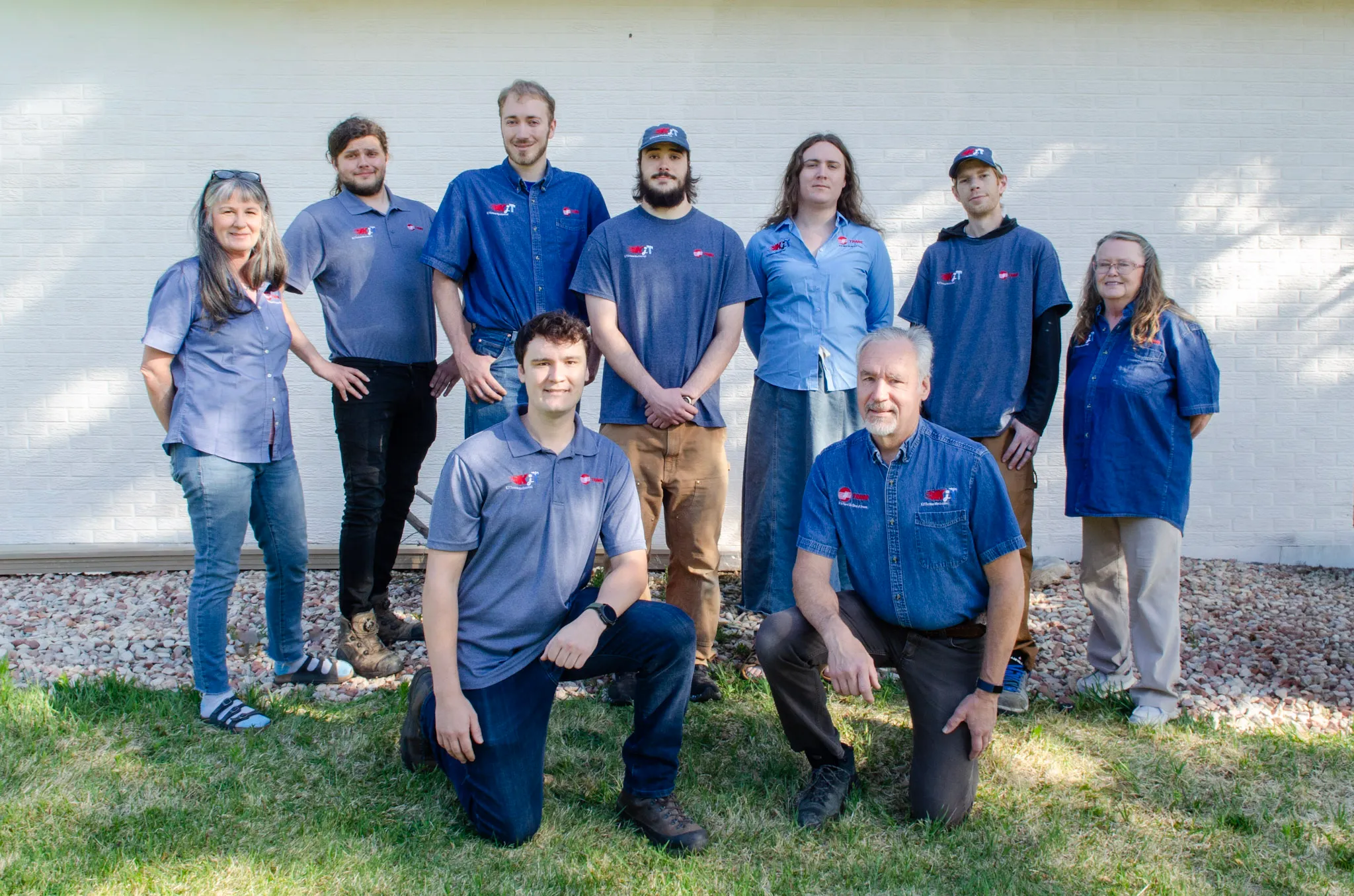 The KJ Thomas Mechanical team standing together outside the shop.