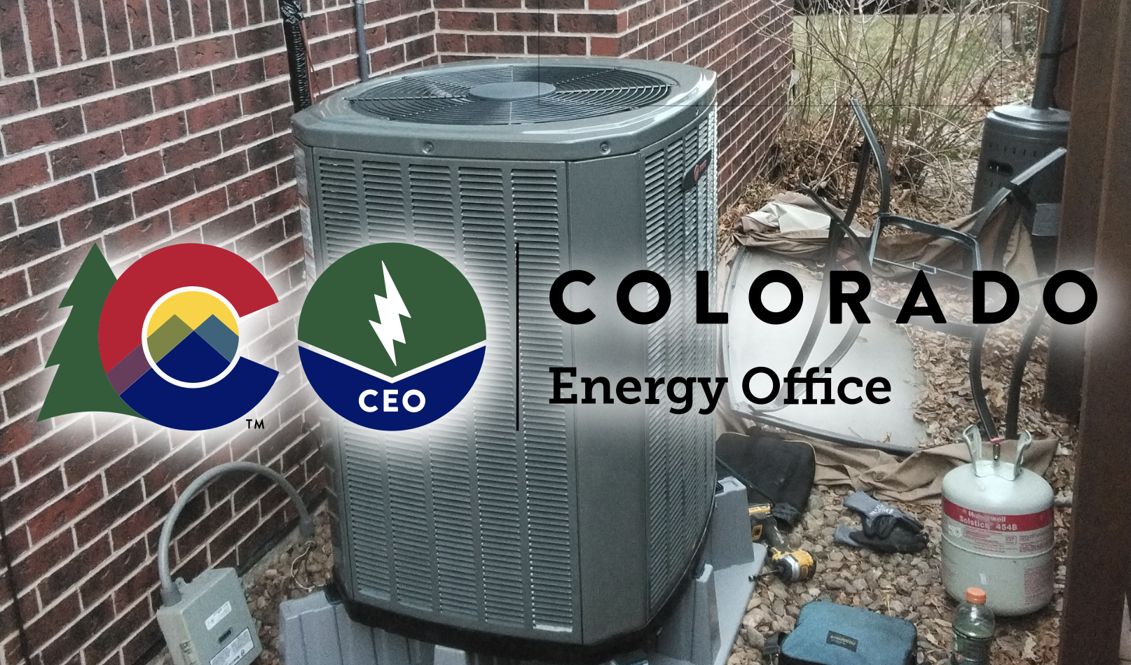 Electric heat pump system installed outside a Boulder County home with mountain foothills in the background